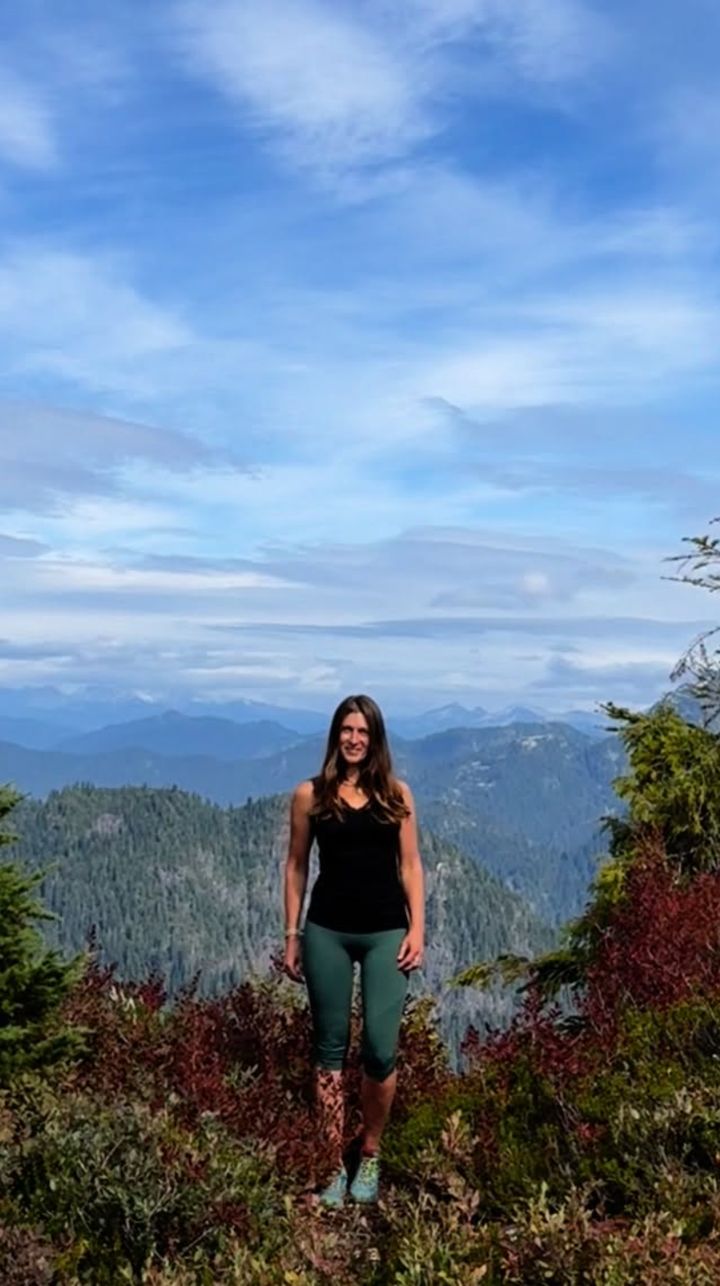 Monika on a mountain ridge among autumn huckleberry bushes